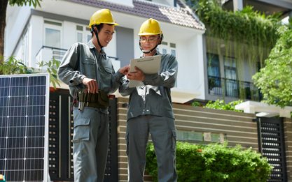Solar panel installation team setting up panels on a residential rooftop