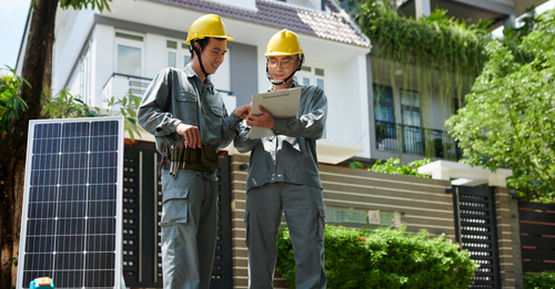 Solar panel installation team setting up panels on a residential rooftop