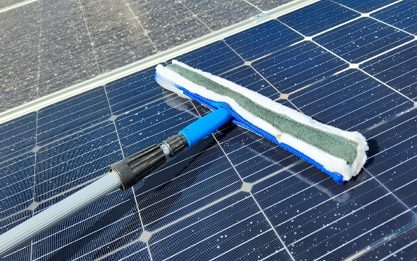 Solar panel cleaning brush being used to clean solar panels efficiently